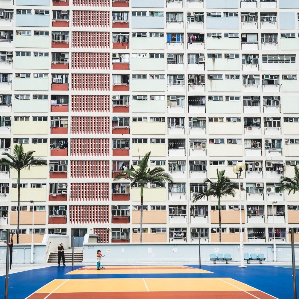 Tennis court in front of modernist building